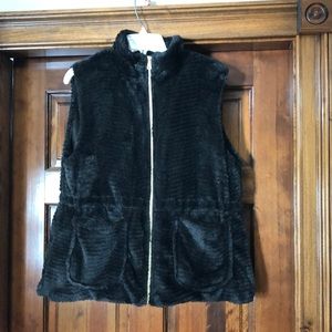 Black faux fur vest with quilted lining.